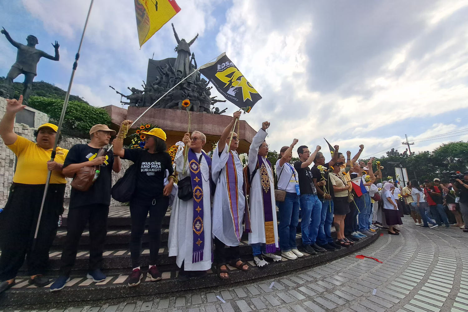 ピープルパワーモニュメントの前で抵抗歌「バヤン・コ（我が祖国）」を歌う、１兆ペソ行進に参加した主要市民団体やカトリック団体の代表ら