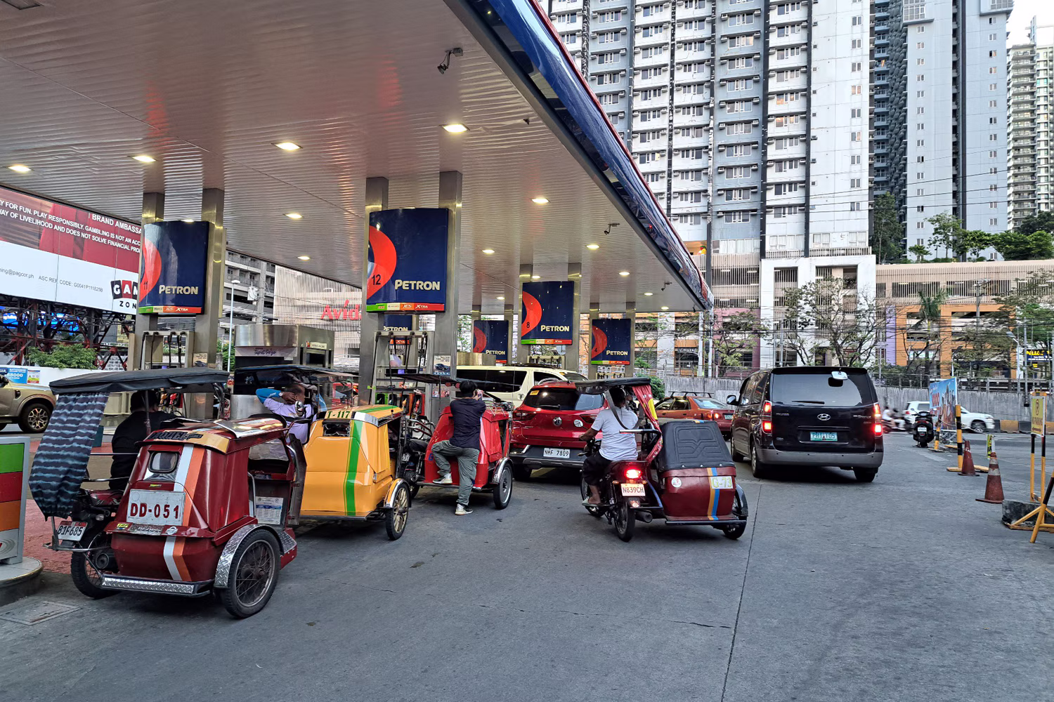 石油製品価格が10日に引き上げられる前に給油しようと列を作る自動車やトライシクルの運転手ら